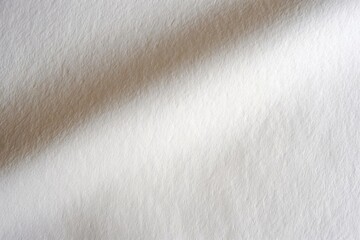 Close-up of a soft, white textured fabric with a subtle shadow. Ideal for backgrounds, textile design, and creative projects.