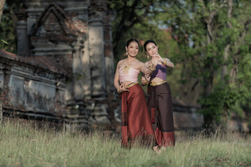 Portrait woman in Thai traditional with Thai dance in historic site on background. Portrait women in traditional clothing , Thai traditional in Ayutthaya, Thailand.