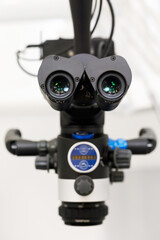 dental microscope, focus on binoculars in dentist office