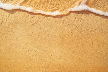 A serene close-up of a golden sandy beach with bubbly waves washing ashore, capturing the essence...