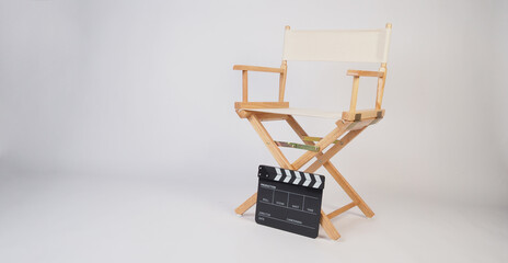 Director chair with clapper board on white background..