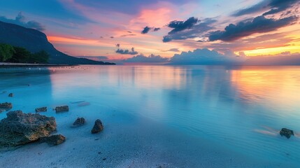 Fototapeta premium A tranquil bay with calm, shallow waters, the sunset creating a gradient of warm colors across the sky.