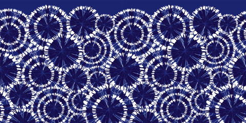 Vector blue shibori circle wheels overlap horizontal border pattern. With spiderweb detail. Suitable for invitation cards and posters.