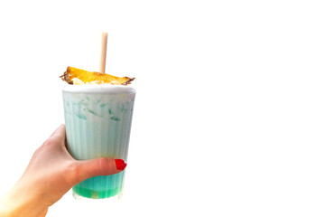 Womans hand with red nails holding a glass with a swimming pool cockatail on the white background with copy space