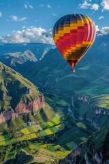 Fototapeta premium A brightly colored hot air balloon floating over a stunning valley landscape.