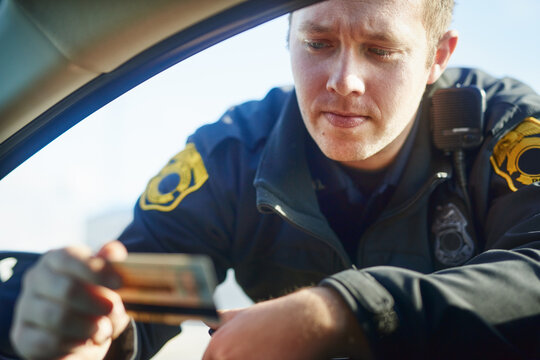 Man, check and traffic officer with license for checkpoint, security and crime investigation or fine. Police, window and driver registration for car accident, dui or road safety with counterfeit card