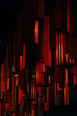Vertical photo of red lights in a restaurant, red and black vertical geometric lines, shapes, orange, 