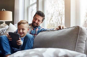 Man, child and tablet on sofa with internet for educational gaming, movie bonding and online tv...