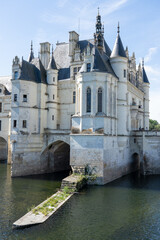a large white country mansion with normandy style turrets, French Chateau on water