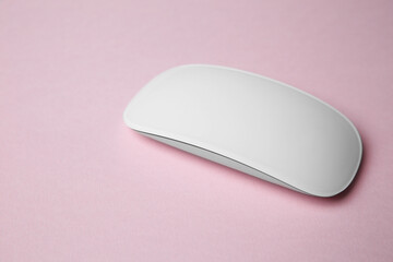 One wireless mouse on pink background. Space for text