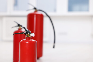 Obraz premium Fire extinguisher indoors, closeup. Space for text