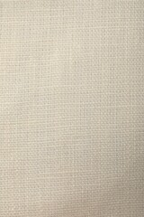 Texture of pale yellow fabric as background, top view