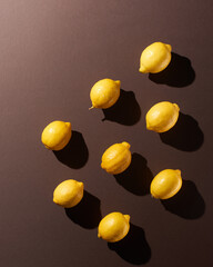 Lemons on brown background with shadows