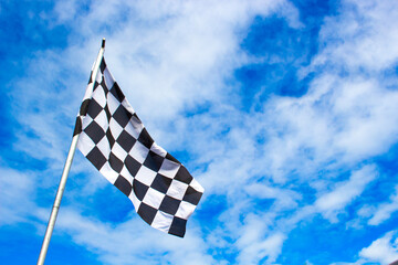 rally sorts checkered flag on blue sky background