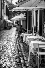 Street cafe on the street of the old city, early morning and empty tables waiting for visitors, vertical shot