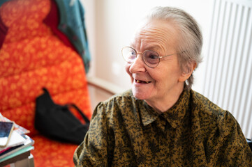 Expressive portrait of an 85 yo grandmother sitting in a wheelchair, Tienen, Belgium