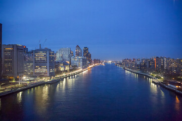 New York City, New York, USA - Drone view of the East River, Roosevelt Island, the FDR drive with the Triboro Bridge in the distance