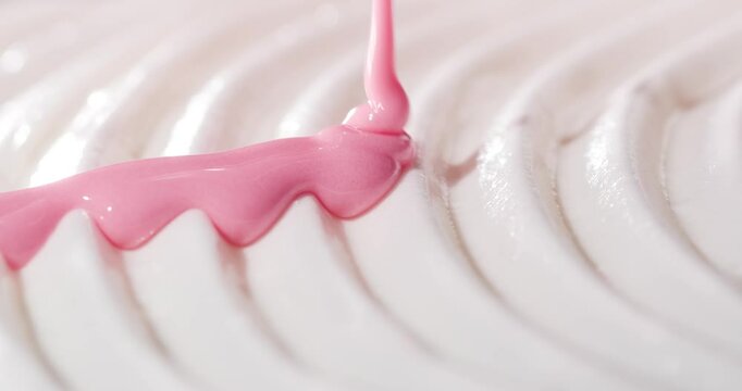 Decorating the cake with pink cream.
