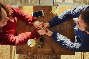 Restaurant, table and people holding hands with couple on anniversary, date and empathy with care....
