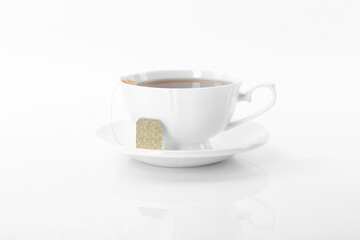 Tasty tea in cup on white background