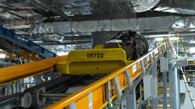 Moving luggage passes on airport baggage conveyor belts. Unmanned shooting. High-tech luggage handling system