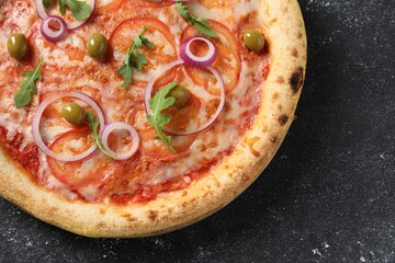 Delicious vegetarian pizza on black table, top view