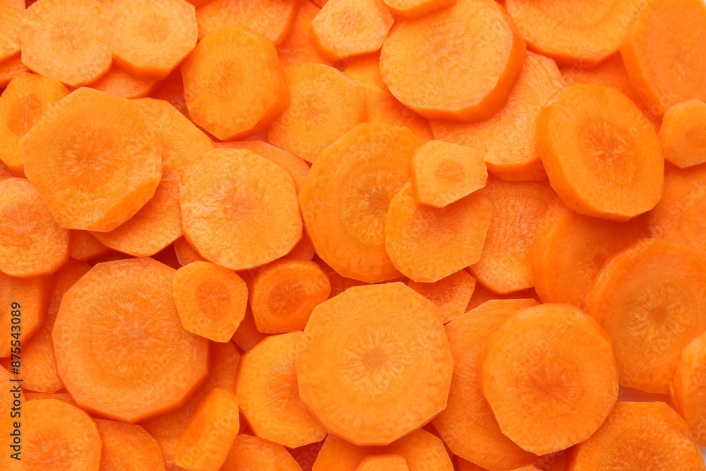 Wall mural Slices of fresh ripe carrot as background, top view