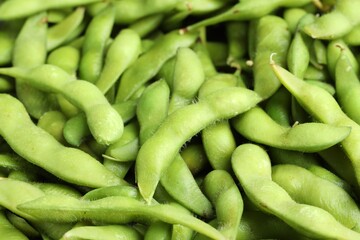 Fresh edamame pods as background, above view