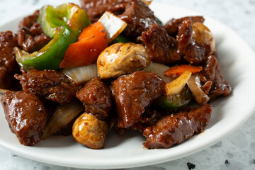 A closeup view of a plate of pepper steak.