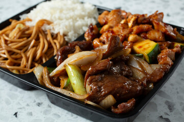 A closeup view of a 2-item combo, featuring Mongolian beef and kung pao chicken.