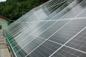 Black solar panels on a red tile roof