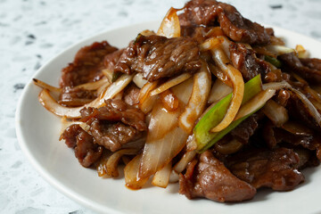 A closeup view of a plate of Mongolian beef.