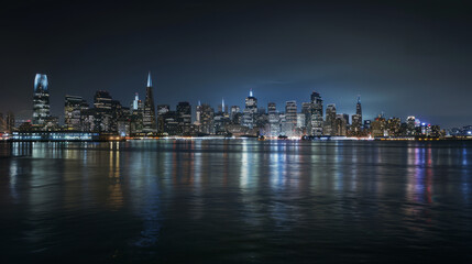 Fototapeta premium Panoramic view of San Francisco's skyline at night from Treasure Island. A startup company is launching a project to find and develop a successful business model for holograms.