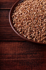 Uncooked Buckwheat Grains on Wooden Boards, Copy Space