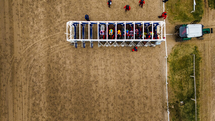Jockeys and trainers prepare the horses for the start of a race at the Palermo Racecourse, Buenos...
