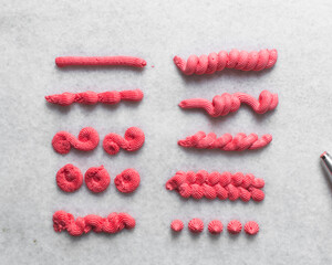 Pink buttercream piped using a open star nozzle, buttercream piped using a small open star piping...