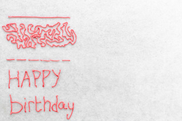 Pink buttercream piped using a writing nozzle, buttercream piped using a small open piping tip on a...