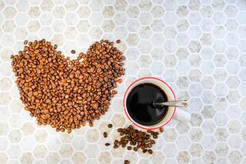 A cup of coffee and coffee beans