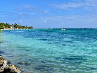 view of a seaside of Guadeloupe in the French West Indies with a turquoise lagoon and a beach lined...