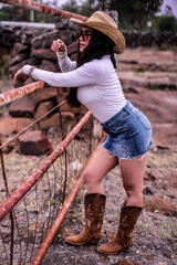 Mexican, western cowgirl with a whip in a sheriff hat. Mexican con botas y sombrero de vaquero, muy...