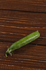 Close up of green Peas on the rustic wooden table