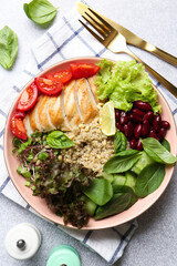 Healthy meal. Tasty vegetables, quinoa and chicken breast in bowl on white table, flat lay