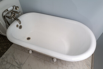 A vintage clawfoot bathtub in a modern bathroom