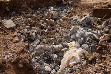 Rusty metal and steel rods discovered on a construction site amidst other equipment and debris