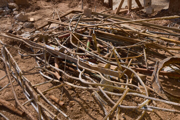 Rusty metal and steel rods discovered on a construction site amidst other equipment and debris