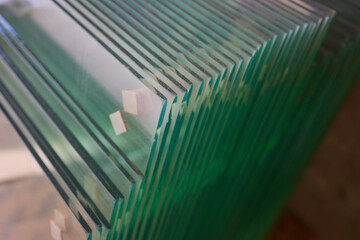 The clear glass sheets are meticulously stacked, creating a modern and elegant look