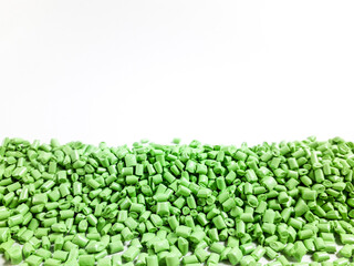 Matcha green masterbatch granules on white background.Color pigment carrier polymer in plastic...