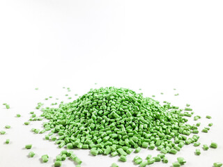 Matcha green masterbatch granules on white background.Color pigment carrier polymer in plastic...
