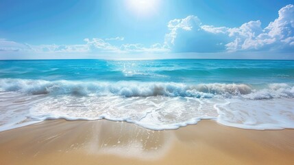 Idyllic sandy beach with gentle waves and vibrant blue sea under a bright sunny sky.