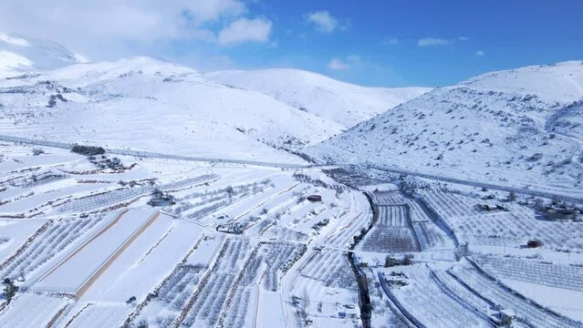 Aerial Forward Scenic Shot Of Snow Covered Mountain Range During Winter Season - Majdal Shams, Israel